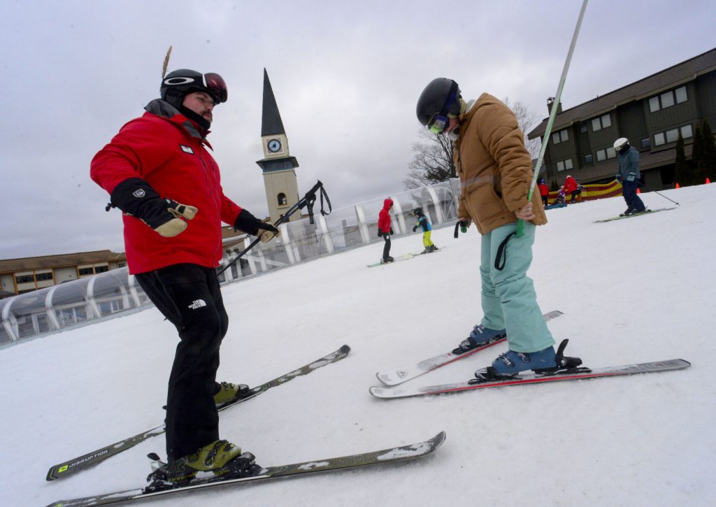 Alan-Rechetelo-a-ski-instructor-at-Stratton-Mountain-Resort-helps-Jennifer-Brandt-learn-how-to-ski-Vermont-Country-Magazine