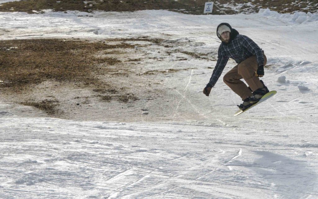 Tyler Talamini, of Brattleboro, gets some air while snowboarding at the Brattleboro Ski Hill at Living Memorial Park in January 2023-vermont country magazine