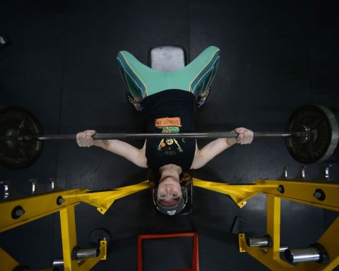 Tina Dalton bench presses during training at Supreme Fitness in May 2023. Kristopher Radder — Vermont Country Magazine.