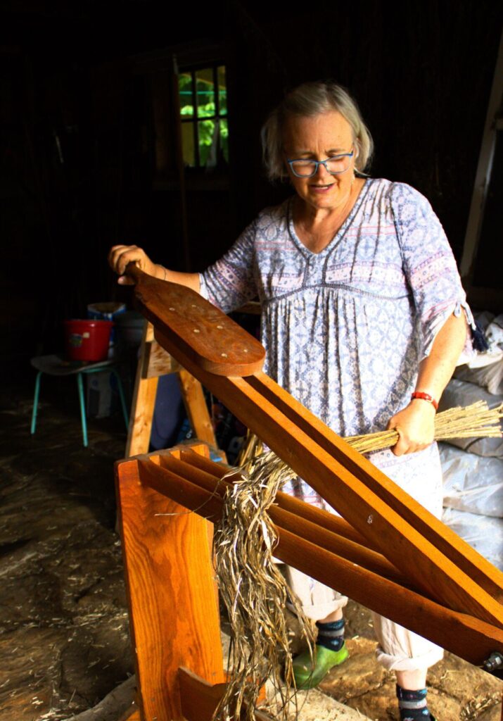 Danielle M. Crosier — Vermont Country Using a flax brake, Andrea Myklebust frees the flax fibers from the outer skin and inner core